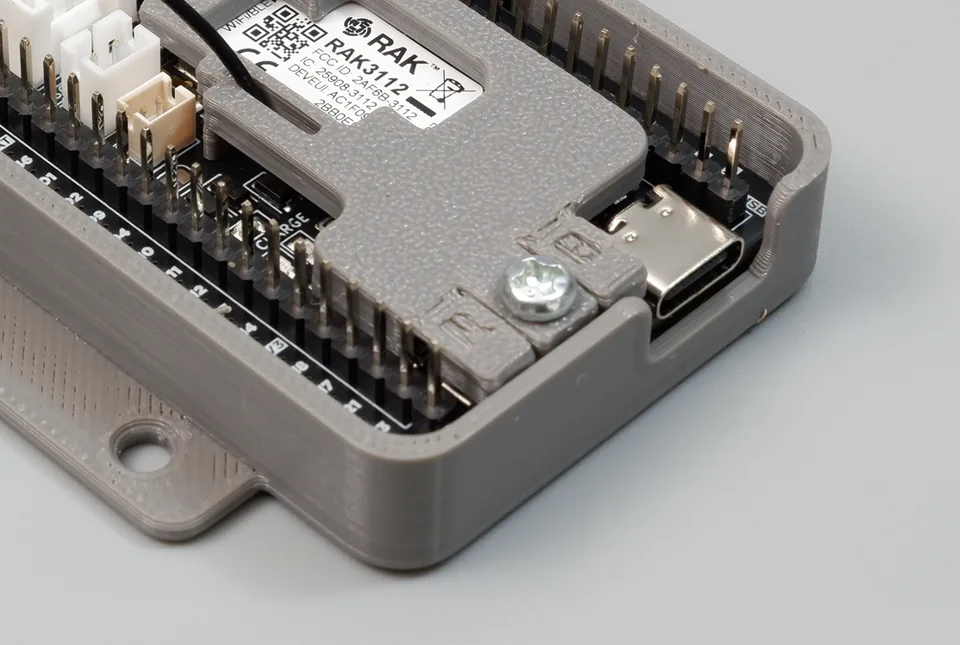 Macro view of the 3D-printed flexible RST and BOOT button covers on the antenna locker plate