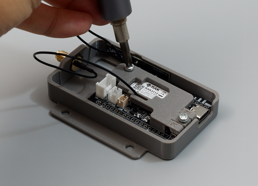 Fastening M3 screws through the antenna locker plate and Devboard into the baseplate standoffs