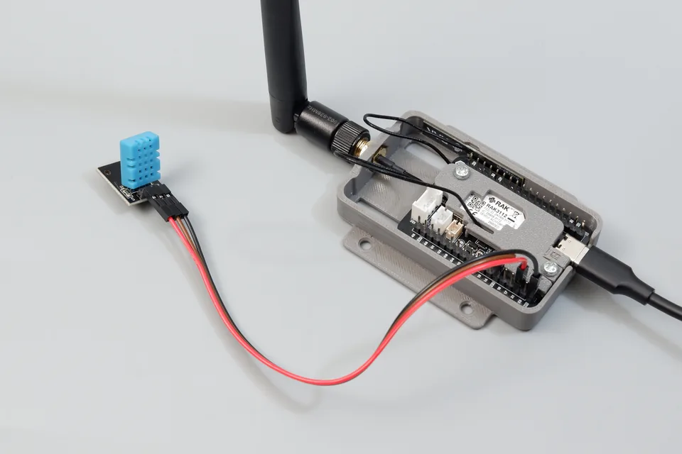 Cubicore Devboard in enclosure connected to a DHT11 temperature and humidity sensor module